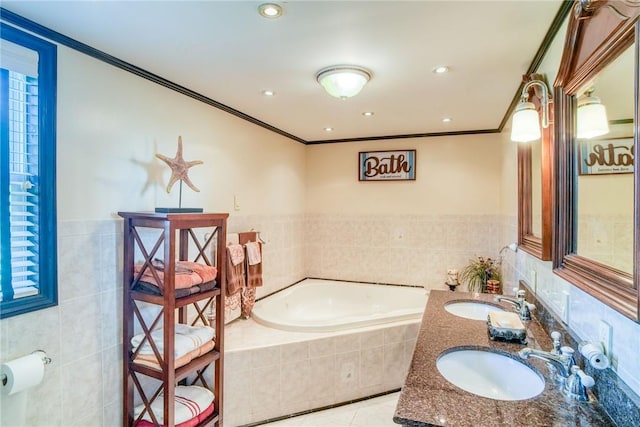 bathroom featuring tiled bath, crown molding, tile patterned flooring, and vanity