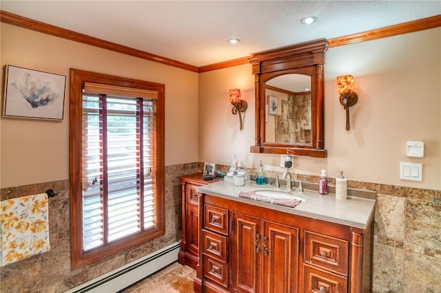 bathroom with vanity, baseboard heating, ornamental molding, and tile walls