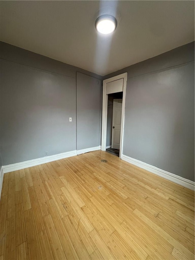 empty room with light hardwood / wood-style flooring