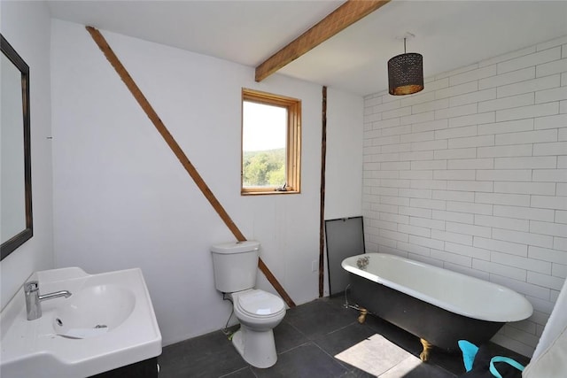 bathroom featuring toilet, a bath, vanity, and tile patterned floors