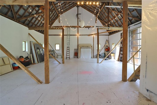 miscellaneous room featuring lofted ceiling and concrete flooring