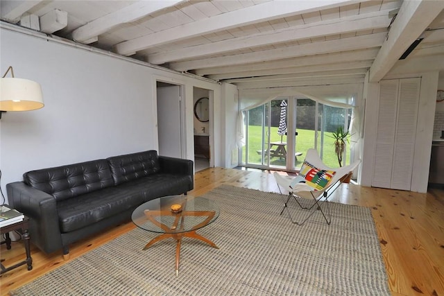 living room featuring beam ceiling and hardwood / wood-style flooring