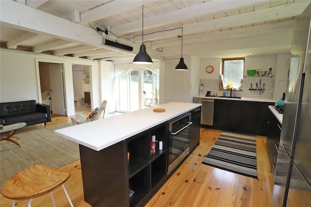 kitchen featuring tasteful backsplash, light hardwood / wood-style flooring, and a healthy amount of sunlight