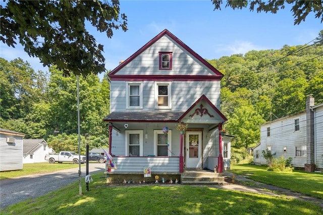 view of front facade featuring covered porch and a front yard