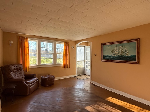 79 Powder House Rd, Amenia, NY 12501 - sitting room featuring arched walkways, dark wood finished floors, and baseboards
