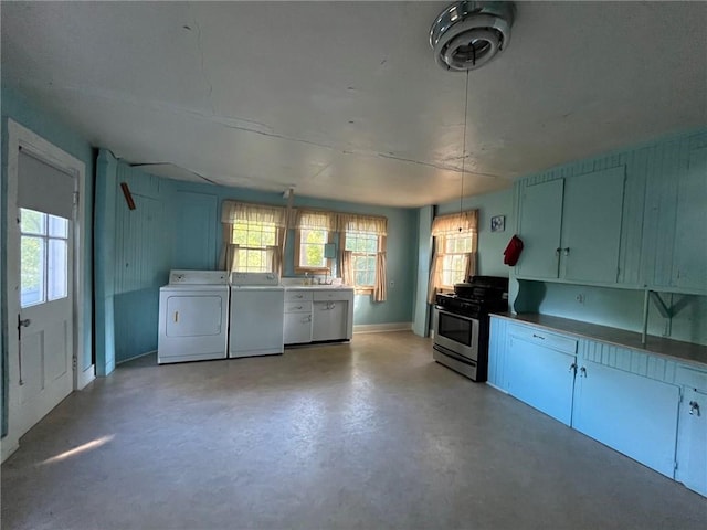 kitchen featuring stainless steel gas stove, washer and dryer, and hanging light fixtures