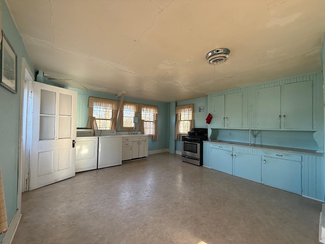 79 Powder House Rd, Amenia, NY 12501 - kitchen with stainless steel gas range oven, washer and clothes dryer, concrete flooring, and baseboards