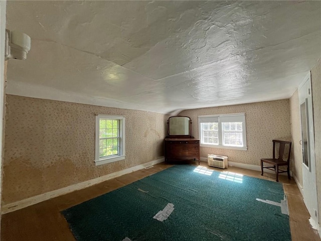 bonus room featuring a healthy amount of sunlight, vaulted ceiling, and wood-type flooring