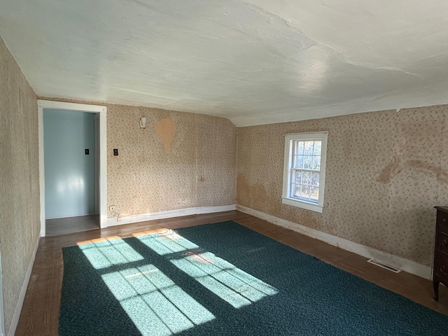 unfurnished room with dark wood-type flooring