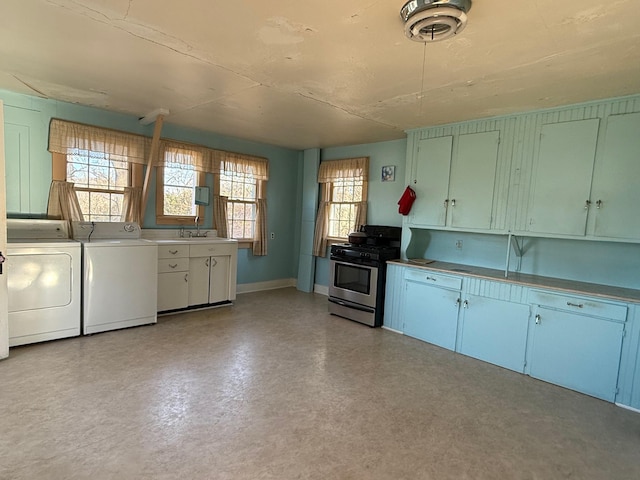 kitchen featuring washer and clothes dryer, sink, and stainless steel range with gas stovetop