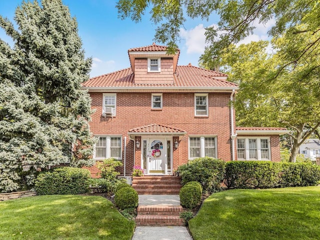 mediterranean / spanish-style home with a front lawn