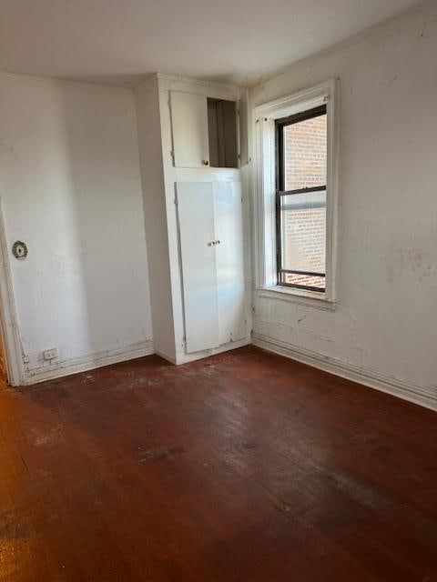 unfurnished room featuring dark hardwood / wood-style flooring