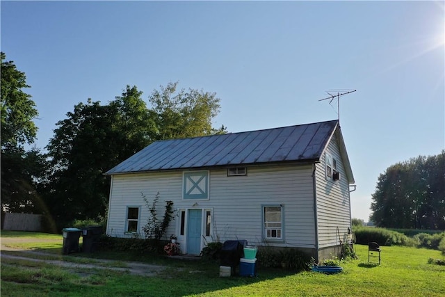 back of property with a lawn