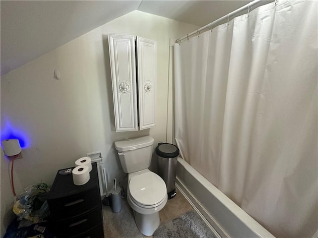 bathroom featuring shower / bath combination with curtain, vaulted ceiling, and toilet