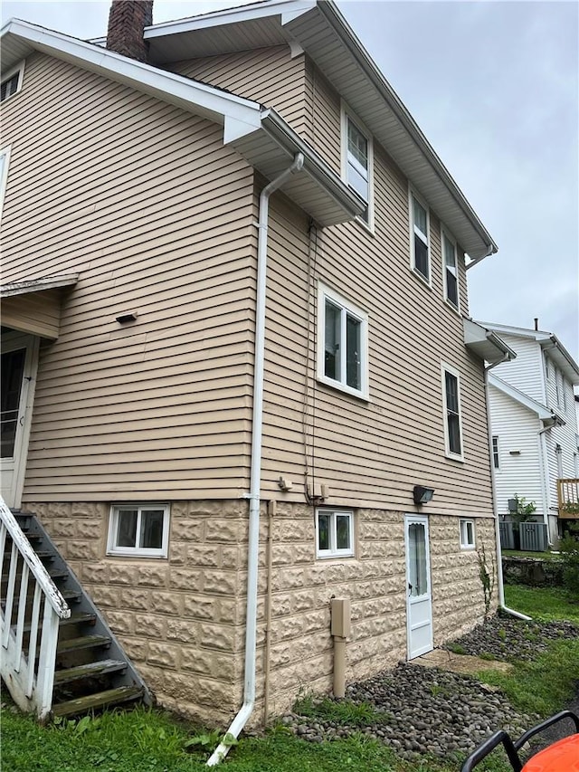 view of side of home with central AC unit