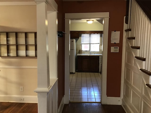 corridor with wood-type flooring and sink