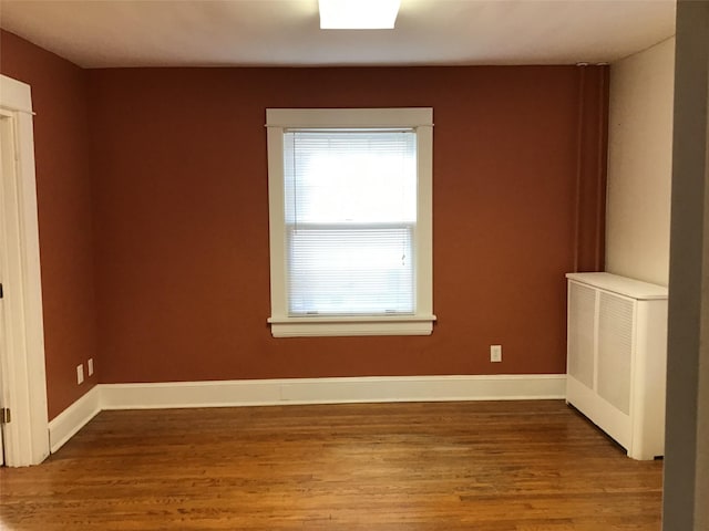 spare room with hardwood / wood-style flooring