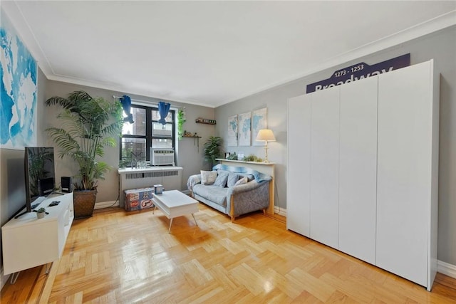 living room featuring light parquet flooring, radiator, and ornamental molding