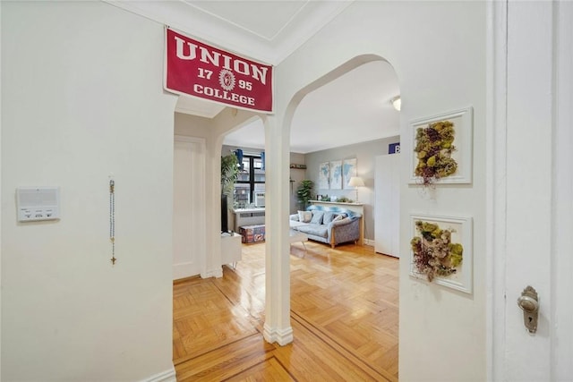 hall featuring parquet flooring and ornamental molding