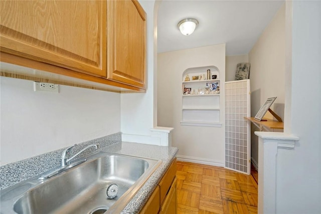 kitchen featuring sink and light parquet flooring