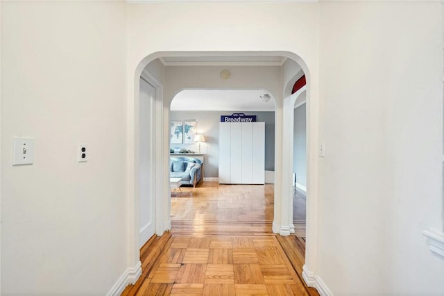 hall with light parquet floors and ornamental molding