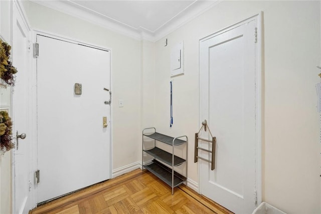 foyer entrance featuring ornamental molding and light parquet floors