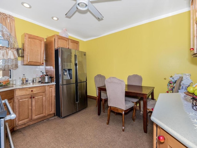 kitchen featuring range, crown molding, decorative backsplash, ceiling fan, and stainless steel fridge with ice dispenser