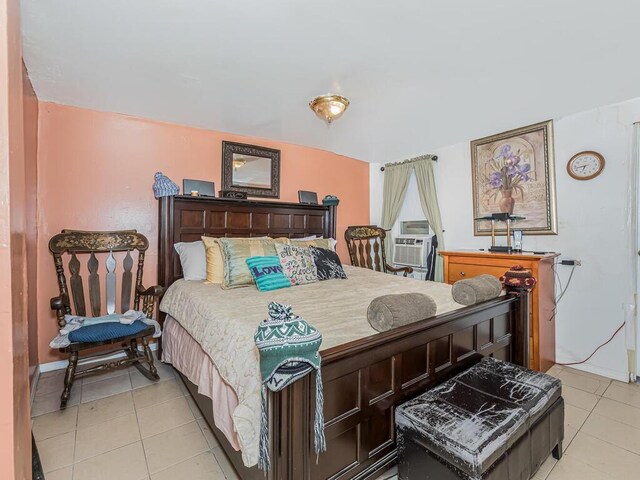 bedroom with cooling unit and light tile patterned flooring