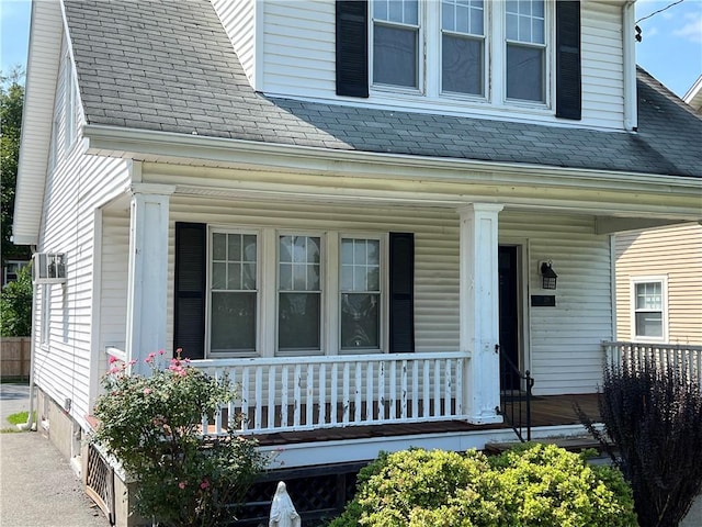 view of exterior entry with a porch