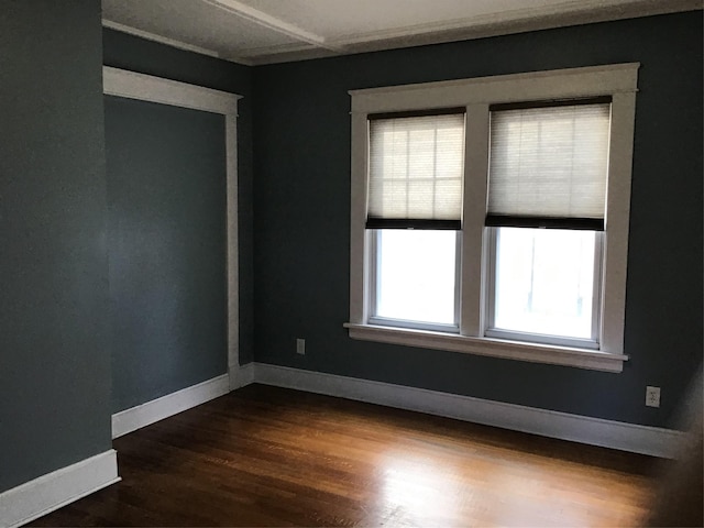 empty room featuring wood ceiling and ornamental molding