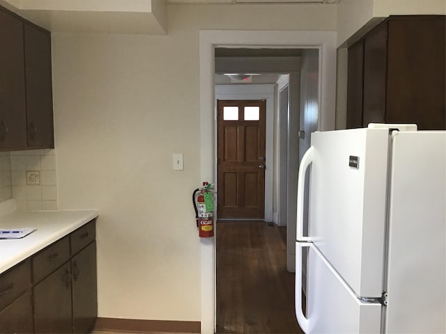 kitchen featuring dark brown cabinets and white refrigerator