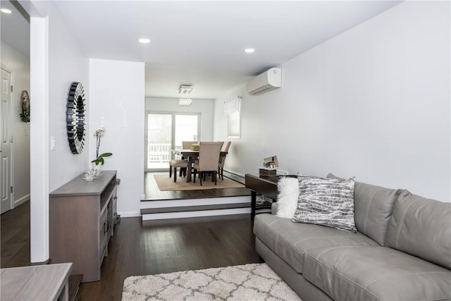 living room with dark hardwood / wood-style floors, a wall unit AC, and a baseboard radiator