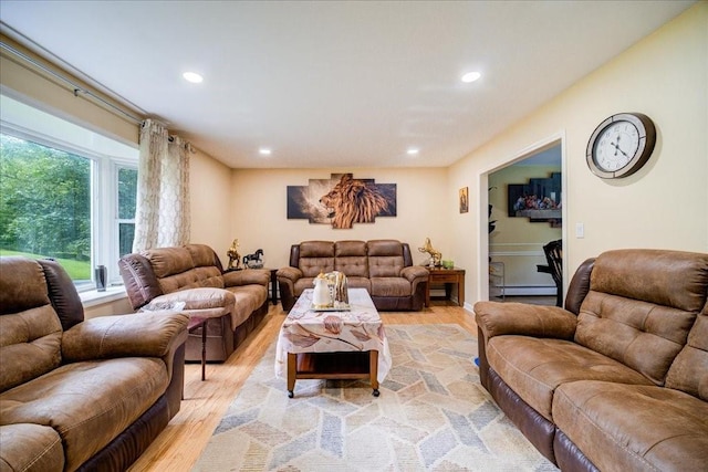 living room featuring baseboard heating and light hardwood / wood-style floors