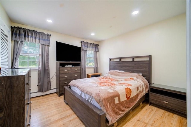 bedroom featuring light hardwood / wood-style floors and a baseboard radiator