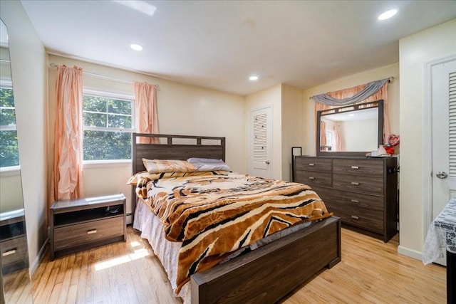 bedroom featuring light wood-type flooring and a closet