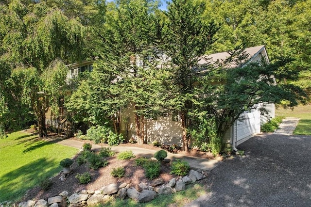 exterior space with a garage and a front lawn