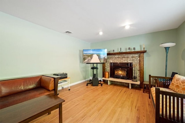 living area featuring wood-type flooring and a fireplace