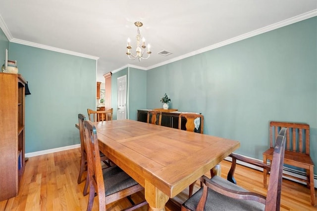 dining room featuring a chandelier, light hardwood / wood-style floors, baseboard heating, and crown molding