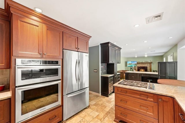 kitchen featuring light stone countertops and stainless steel appliances