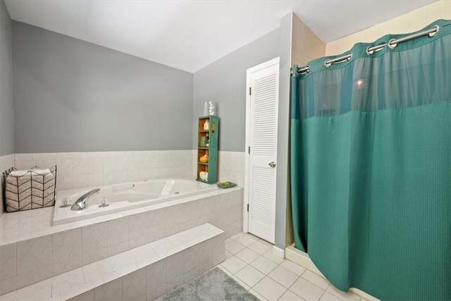 bathroom featuring tile patterned flooring and tiled tub