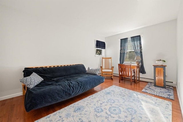 living room featuring a wall unit AC, hardwood / wood-style floors, and a baseboard heating unit