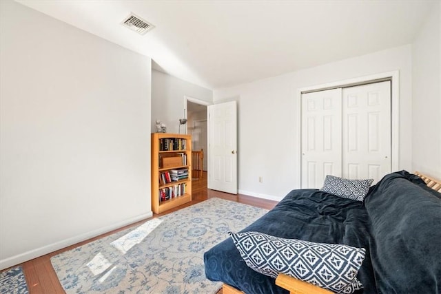 bedroom with wood-type flooring and a closet