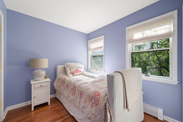 bedroom with dark wood-type flooring