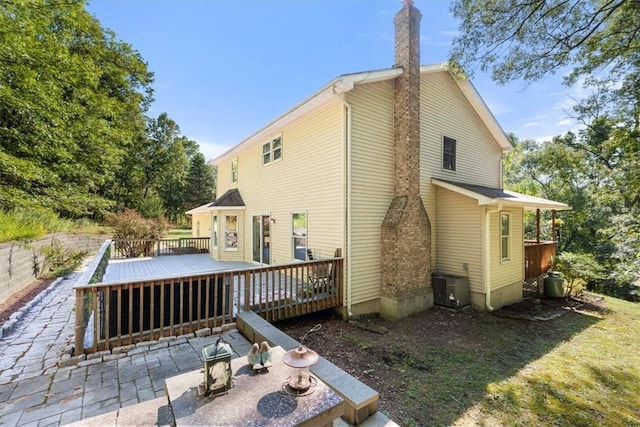 back of house featuring cooling unit, a patio, and a wooden deck