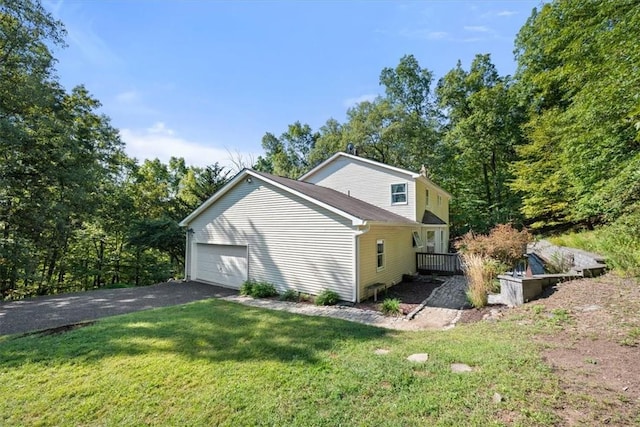 view of side of home with a lawn and a garage