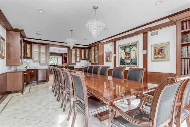 dining room featuring crown molding and an inviting chandelier