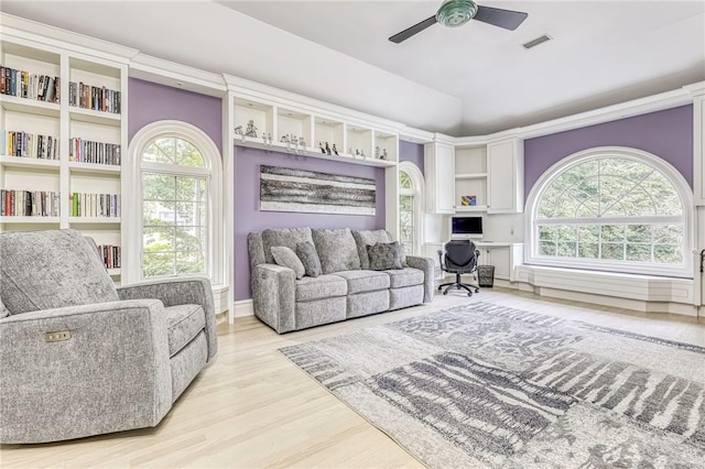 living room featuring light hardwood / wood-style floors and ceiling fan