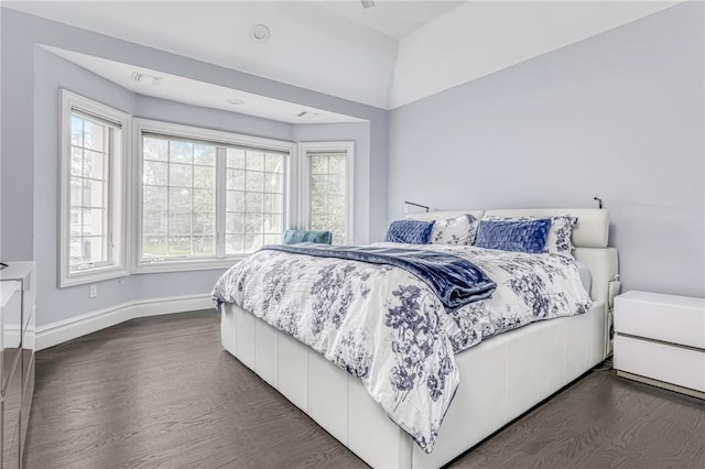 bedroom with dark hardwood / wood-style flooring