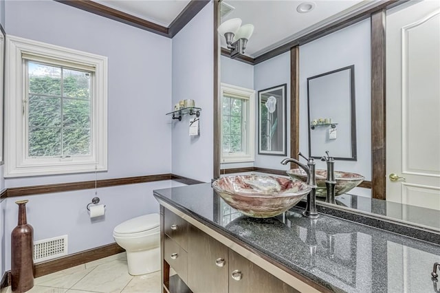 bathroom featuring crown molding, vanity, and toilet