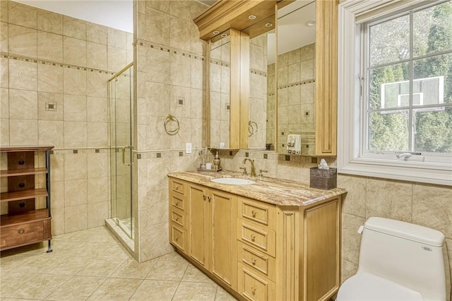 bathroom with an enclosed shower, vanity, tile walls, tile patterned flooring, and toilet